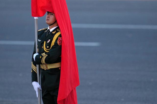 A Chinese honor guard holds the national flag of China during a welcoming ceremony held for the visit of Germany’s President Frank-Walter Steinmeier outside the Great Hall of the People in Beijing on October 30, 2026. (Photo by Kai Naito / POOL / AFP)