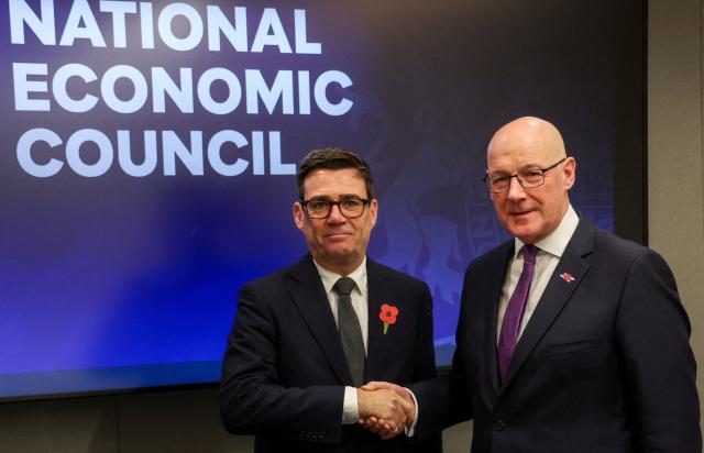 Britain's Prime Minister Andy Burnham shake hands with Scotland's First Minister John Swinney during a meeting at the National Economic Council in Glasgow on October 30, 2026, that focuses on driving growth in every region of the United Kingdom. (Photo by Russell Cheyne / POOL / AFP)