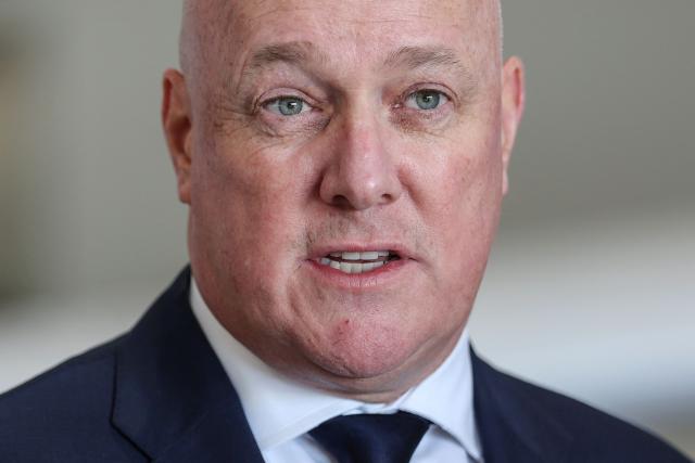 (FILES) New Zealand's Prime Minister Christopher Luxon speaks to media during a visit to aircraft manufacturing company 'NZ Aero' in Auckland on August 21, 2026. Luxon told AFP on October 30, 2026, planned cuts to foreign aid would make sure the country spends less money on "nice-to-do" but frivolous projects abroad, and he vowed to push for new free trade deals from Brazil to Bangladesh if re-elected next week. (Photo by Michael Bradley / AFP)