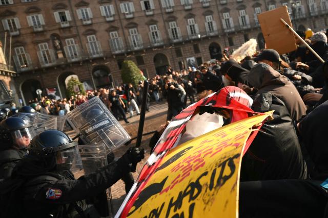 Protesters clash with Carabinieri during a demonstration part of a nationwide day of strikes and protests as school and university students demand more funding for schools and support for housing, inTurin on October 30, 2026. Students have been protesting for weeks, setting up tent camps and occupying schools to make their demands heard, matching similar movements across the border in France. The Italian protests have taken place alongside those of truck drivers and farmers over the spike in fuel prices and the cost of living, as well as rising defence spending. (Photo by Marco BERTORELLO / AFP)