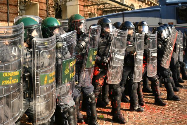 Guardia di Finanza and Carabinieri officers face protesters during a demonstration part of a nationwide day of strikes and protests as school and university students demand more funding for schools and support for housing, inTurin on October 30, 2026. Students have been protesting for weeks, setting up tent camps and occupying schools to make their demands heard, matching similar movements across the border in France. The Italian protests have taken place alongside those of truck drivers and farmers over the spike in fuel prices and the cost of living, as well as rising defence spending. (Photo by Marco BERTORELLO / AFP)