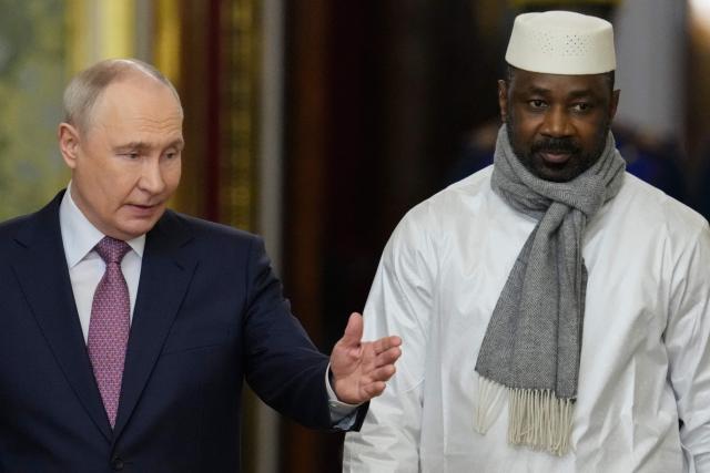 Russia's President Vladimir Putin (L) and Mali's junta leader Assimi Goita (R) arrive for their talks on the sidelines of the Russia-Africa summit in Moscow on October 30, 2026. (Photo by Pavel Bednyakov / POOL / AFP)