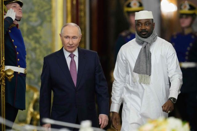 Russia's President Vladimir Putin (L) and Mali's junta leader Assimi Goita (R) arrive for their talks on the sidelines of the Russia-Africa summit in Moscow on October 30, 2026. (Photo by Pavel Bednyakov / POOL / AFP)