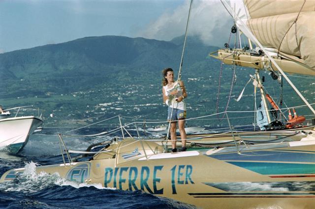 (FILES) French skipper Florence Arthaud sails aboard her sailboat "Pierre 1er" to arrive in first position of the 4th edition of the Route du Rhum sailing race at Pointe-a-Pitre, in the French overseas island of Guadeloupe on November 18, 1990. From Saint-Malo in French Brittany to Pointe-a-Pitre in Guadeloupe, 115 skippers across 6 classes will take the start of the 13th edition of the Route du Rhum - Destination Guadeloupe on November 1, 2026, in this solo transatlantic sailing race. (Photo by MARCEL MOCHET / AFP)