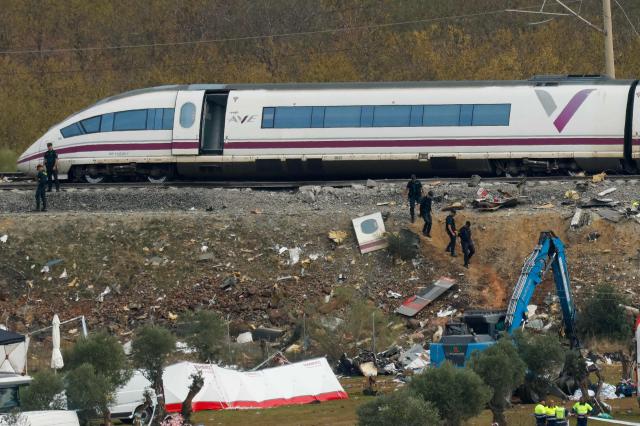 Investigators and emergency services work near wrecked carriages of a train crash between a Renfe AVE train and an Iryo train, two days after the deadly accident in Urda, in the province of Toledo on October 30, 2026. A high-speed train collision south of Madrid killed 69 people and injured scores more on October 28, 2026 authorities said, in one of Europe's deadliest such disasters this century. The second such accident to strike Spain this year will raise fresh questions about the country's rail safety, with the transport minister speaking of an "error" and "inexplicable circumstances" that led to the crash. (Photo by Oscar DEL POZO / AFP)