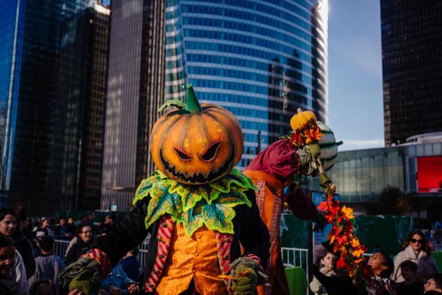 Performers wearing pumpkin-headed costumes attend a Halloween-themed party in the La Defense business district in Puteaux, near Paris, on October 30, 2026. (Photo by DIMITAR DILKOFF / AFP)