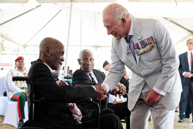 King Charles III (R) meets with World War II and pre-independence veterans at the Commonwealth War Graves in Georgetown on October 30, 2026. King Charles III is on an official visit to Guyana. (Photo by Chris Jackson / POOL / AFP)