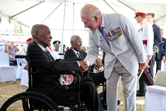 King Charles III (R) meets with World War II and pre-independence veterans at the Commonwealth War Graves in Georgetown on October 30, 2026. King Charles III is on an official visit to Guyana. (Photo by Chris Jackson / POOL / AFP)