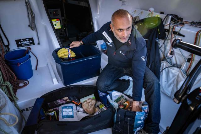 French skipper Fabrice Amedeo organises his meals as he restocks his Imoca monhull Fdj United - Ocean Calling in the harbour of Saint-Malo, northwestern France on October 30, 2026, a few days prior to the start of La Route du Rhum - Destination Guadeloup solo sailing race from Saint-Malo to Pointe-a-Pitre in the French overseas island of Guadeloupe. (Photo by Lou BENOIST / AFP)