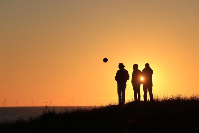 People look at the sunset in La Gueriniere, on Noirmoutier island, western France on October 30, 2026. (Photo by Ludovic MARIN / AFP)