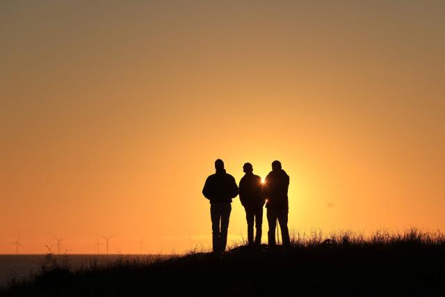 People look at the sunset in La Gueriniere, on Noirmoutier island, western France on October 30, 2026. (Photo by Ludovic MARIN / AFP)