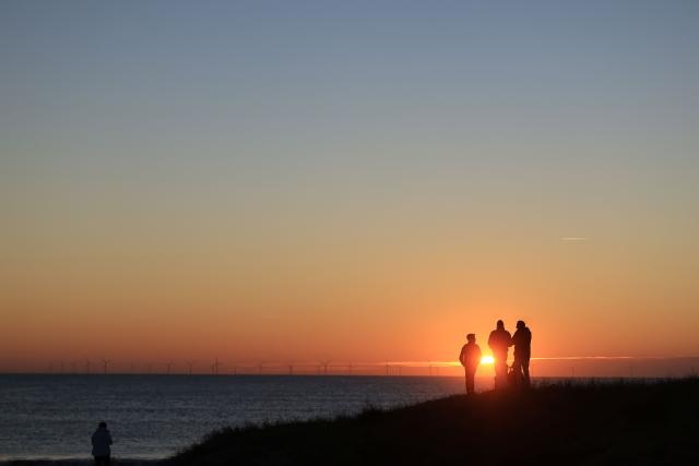 People look at the sunset in La Gueriniere, on Noirmoutier island, western France on October 30, 2026. (Photo by Ludovic MARIN / AFP)