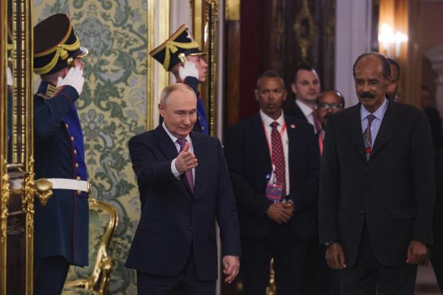Russia's President Vladimir Putin (L) and Eritrea's President Isaias Afwerki (R) arrive for their talks on the sidelines of the Russia-Africa summit in Moscow on October 30, 2026. (Photo by MAXIM SHIPENKOV / POOL / AFP)