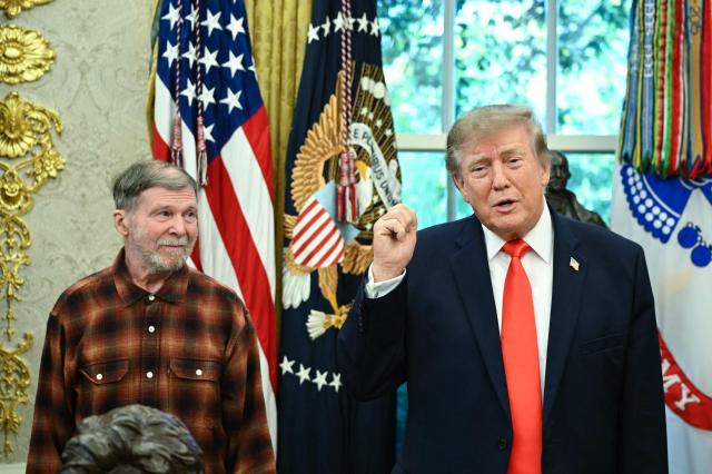 US President Donald Trump speaks alongside Stephen Hubbard (L) in the Oval Office of the White House in Washington, DC, on October 30, 2026. Hubbard, a retired US teacher, returned to the United States on October 22, 2026, after being released by Russia following four years in Russian prison. (Photo by Alex WROBLEWSKI / AFP)