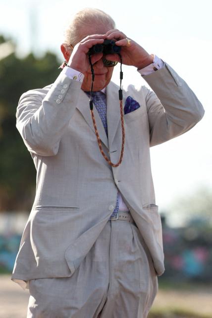 Britain's King Charles III looks through binoculars during a visit to the Kingston Seawall in Georgetown on October 30, 2026. King Charles III is on an official visit to Guyana. (Photo by Isabel Infantes / POOL / AFP)