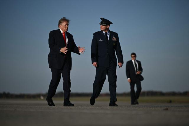 US President Donald Trump gestures as he walks to board Air Force One at Joint Base Andrews, Maryland, on October 30, 2026. President Trump is travelling to Florida to speak at a midterm campaign rally. (Photo by Brendan SMIALOWSKI / AFP)