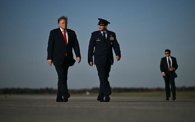 US President Donald Trump walks to board Air Force One at Joint Base Andrews, Maryland, on October 30, 2026. President Trump is travelling to Florida to speak at a midterm campaign rally. (Photo by Brendan SMIALOWSKI / AFP)