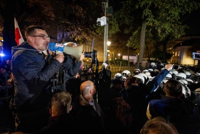 A man shouts slogans with megaphone as protesters gather outside the headquarters of the Poland's Constitutional Court in Warsaw after police blocked access to the court building on October 30, 2026. (Photo by Wojtek RADWANSKI / AFP)