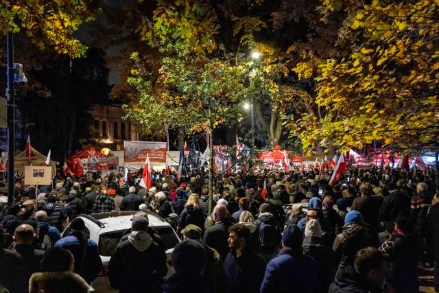 Protesters gather outside the headquarters of Poland's Constitutional Court after police blocked access to the building in Warsaw, Poland on October 30, 2026. Poland's President Karol Nawrocki called off a visit to Africa in mid-flight as riot police deployed around the country's constitutional court on October 30 following the suspension of its chief justice in a battle between the centrist government and the nationalist right. Dozens of police guarded the entrance to the court as followers of the opposition right-wing Law and Justice party (PiS) protested the ousting of constitutional court president Bogdan Swieczkowski. (Photo by Wojtek RADWANSKI / AFP)
