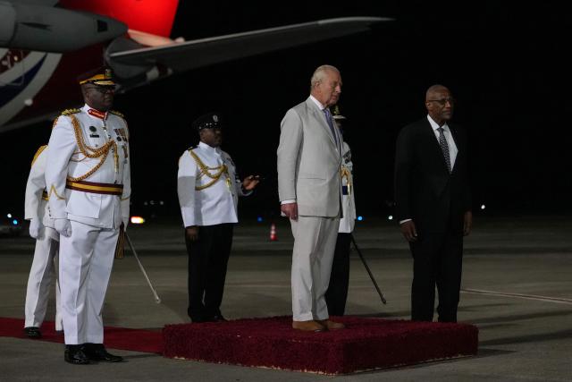 Britain's King Charles III stands alongside the Governor-General of Antigua and Barbuda, Sir Rodney Williams, during a welcoming ceremony upon his arrival at VC Bird International Airport in St. John's, on October 30, 2026. (Photo by Ben Stansall / POOL / AFP)