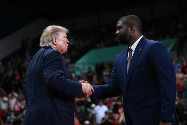 US President Donald Trump shakes hands with gubernatorial candidate US Representative Byron Donalds, Republican from Florida, at a midterm campaign rally at the Ocean Center in Daytona Beach, Florida on October 30, 2026. (Photo by Brendan SMIALOWSKI / AFP)