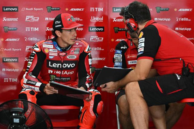 Ducati Lenovo Team's Spanish rider Marc Marquez (L) talks to team members before the second free practice session of the MotoGP Malaysian Grand Prix at the Sepang International Circuit in Sepang on October 31, 2026. (Photo by MOHD RASFAN / AFP)