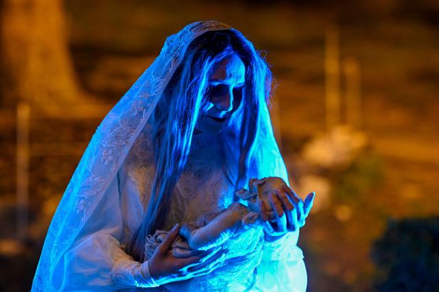 An actress dressed as "La Llorona" performs during "Legends of Guatemala" in the Cerrito del Carmen neighborhood ahead of the Day of the Dead celebrations in Guatemala City on October 30, 2026. (Photo by Johan ORDONEZ / AFP)