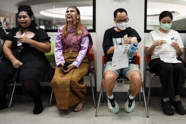 Thai Red Cross staff members dressed in Halloween costumes pose next to people at the National Blood Center of the Thai Red Cross Society in Bangkok on October 31, 2026. (Photo by Chanakarn Laosarakham / AFP)