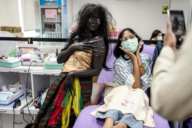 A Thai Red Cross staff member dressed in a Halloween costume poses with a woman donating blood at the National Blood Center of the Thai Red Cross Society in Bangkok on October 31, 2026. (Photo by Chanakarn Laosarakham / AFP)