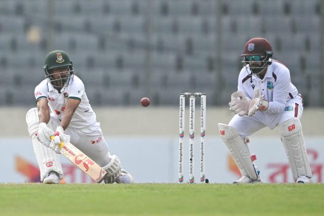Bangladesh's Taijul Islam (L) plays a shot as West Indies' wicketkeeper Amir Jangoo (R) looks on during the fourth day of the first test cricket match between Bangladesh and West Indies at the Sher-e-Bangla National Stadium in Mirpur on October 31, 2026. (Photo by Salahuddin Ahmed / AFP)
