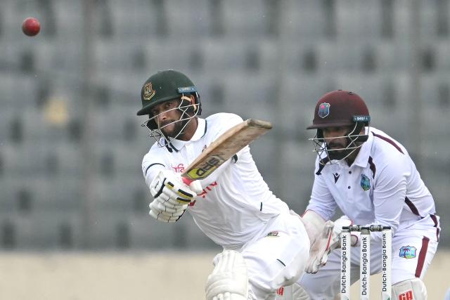 Bangladesh's Nayeem Hasan (L) plays a shot as West Indies' wicketkeeper Amir Jangoo (R) looks on during the fourth day of the first test cricket match between Bangladesh and West Indies at the Sher-e-Bangla National Stadium in Mirpur on October 31, 2026. (Photo by Salahuddin Ahmed / AFP)