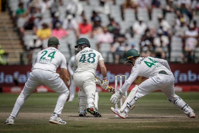 Australia's Josh Inglis (C) is caught behind by South Africa's Ryan Rickelton (R) and dismissed on day five of the third Test match between South Africa and Australia at Newlands stadium in Cape Town on October 31, 2026. (Photo by Marco Longari / AFP)