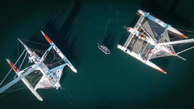This aerial photograph shows multihulls leaving Saint-Malo's harbour, to moor of the coast of Saint-Malo northwestern France on October 31, 2026 a few days prior to the start of the Route du Rhum solo sailing race from Saint-Malo, to Pointe-a-Pitre in the French overseas island of Guadeloupe.  (Photo by LOU BENOIST / AFP)