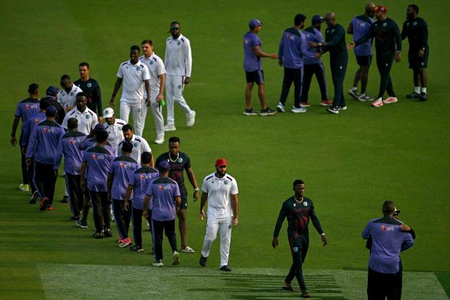 Bangladesh's players (L) shake hands with West Indies' players at the end of the first test cricket match after the latter's victory at the Sher-e-Bangla National Stadium in Mirpur on October 31, 2026. (Photo by Salahuddin AHMED / AFP)
