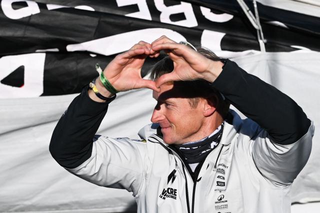 French sailor Maxime Sorel reacts from aboard his "NC" IMOCA Class through the lock of Saint-Malo's harbour to moor off the coast of Saint-Malo, northwestern France on October 31, 2026 on the eve of the start of the Route du Rhum solo sailing race from Saint-Malo, to Pointe-a-Pitre in the French overseas island of Guadeloupe. (Photo by Sebastien Salom-Gomis / AFP)