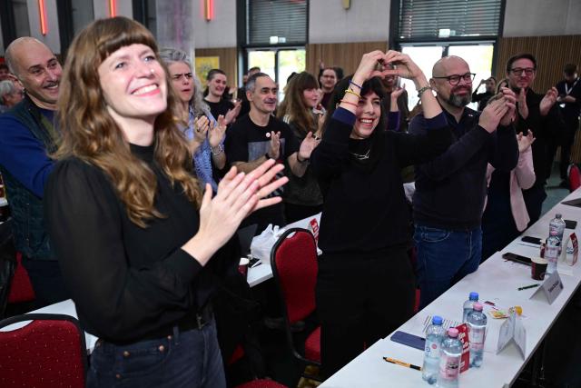 Elif Eralp, parliamentary group leader of the left-wing Die Linke party in Berlin's House of Representatives(C) reacts as she is praised by a speaker during their extraordinary party convention on forming a government following elections in Berlin October 31, 2026. Germany's far-left Die Linke party scored a historic election win in Berlin in September 2026, but its path to power in the city-state has been complicated by its stance on the Israel-Palestinian conflict. Since its ballot box triumph, it has been accused of tolerating "Israel hate" and antisemitism in its ranks -- but also taken heat from members who say it is selling out its pro-Palestinian stance in pursuit of a governing coalition. (Photo by John MACDOUGALL / AFP)