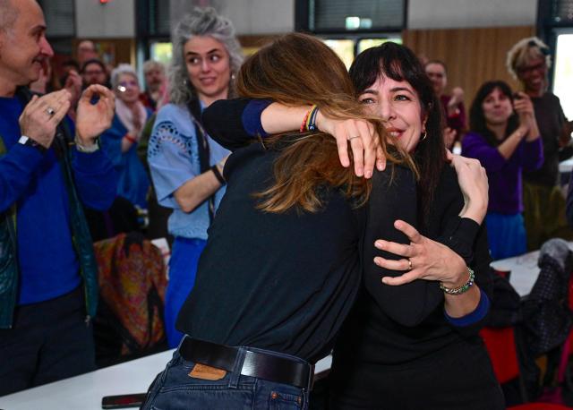 Elif Eralp, parliamentary group leader of the left-wing Die Linke party in Berlin's House of Representatives is embraced by Chairwoman of the left-wing Die Linke party in Berlin Kerstin Wolter during their extraordinary party convention on forming a government following elections in Berlin October 31, 2026. Germany's far-left Die Linke party scored a historic election win in Berlin in September 2026, but its path to power in the city-state has been complicated by its stance on the Israel-Palestinian conflict. Since its ballot box triumph, it has been accused of tolerating "Israel hate" and antisemitism in its ranks -- but also taken heat from members who say it is selling out its pro-Palestinian stance in pursuit of a governing coalition. (Photo by John MACDOUGALL / AFP)