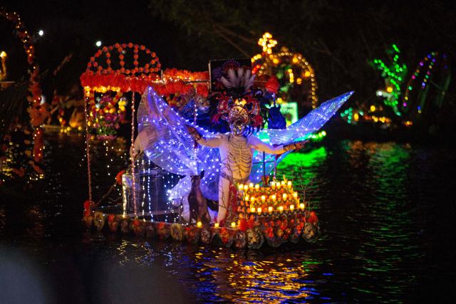 Locals sail small boats adorned with colorful flowers and lights as fishermen pay tribute to their deceased loved ones, as part of the Day of the Dead celebrations, in Sisal, Yucatan, Mexico, on October 30, 2026. (Photo by Hugo Borges / AFP)