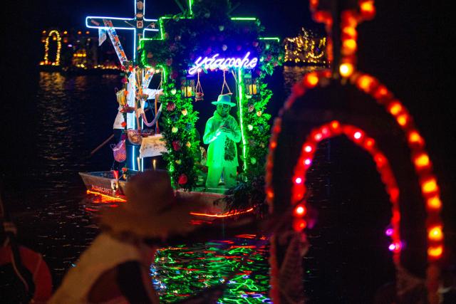 Locals sail small boats adorned with colorful flowers and lights as fishermen pay tribute to their deceased loved ones, as part of the Day of the Dead celebrations, in Sisal, Yucatan, Mexico, on October 30, 2026. (Photo by Hugo Borges / AFP)
