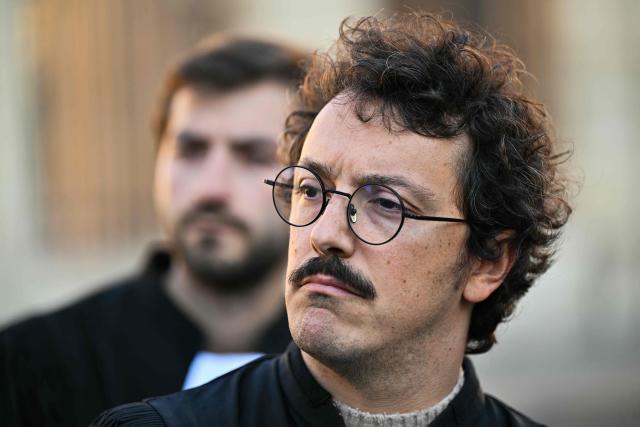 French lawyer and member of the collective "Colere Noire" Romain Ruiz looks on during a gathering of lawyers to protest against the State Council decision to maintain the ban on the Bastille-Nation route for the demonstration over the rising cost of living and inequality organised by Yellow Vest movement, labour unions and high school and university students, in front of the State Council, in Paris on October 31, 2026. In a final twist, the Paris procession will set off at 2:00 p.m. in the eastern part of the capital, following the decision by the Conseil d'État to overturn October 30s ruling by the Paris administrative court. (Photo by Martin LELIEVRE / AFP)
