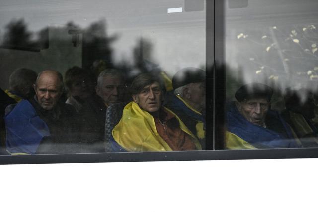 Residents evacuated from the Russian-controlled city of Oleshky during a humanitarian mission react sitting in a bus upon arriving at an undisclosed location in Ukraine on October 31, 2026, amid the Russian invasion of Ukraine. Residents of the Russian-controlled city of Oleshky, ravaged by years of war, arrived in Ukraine on October 31, 2026 after being evacuated via Belarus during a rare truce. (Photo by Genya SAVILOV / AFP)