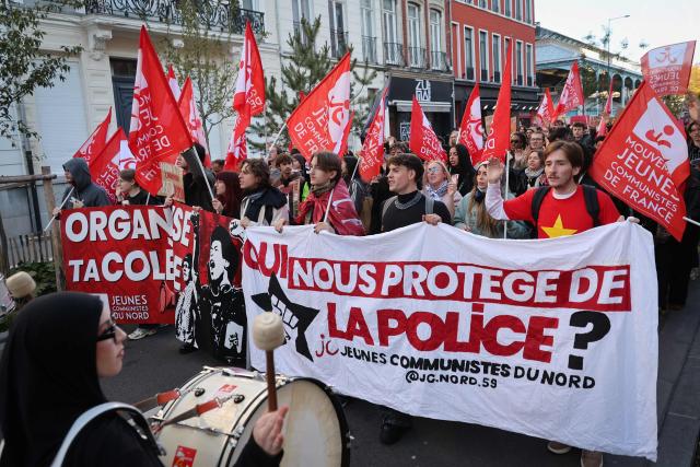Protesters hold banners during nationwide demonstrations over the rising cost of living and inequality organised by Yellow Vest movement, labour unions and high school and university students, in Lille, northern France on October 31, 2026. "Exceptional" security deployment with 70,000 police officers and gendarmes mobilized and an alarmist tone: for Act III of the protests against the high cost of living, right in the middle of Halloween festivities, the authorities fear a repeat of the October 17 nightmare. France has been rocked by widespread anger over the rising cost of living and inequality. (Photo by Francois LO PRESTI / AFP)