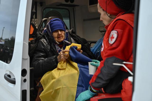 Zinaida, 90, evacuated from the Russian-controlled city of Oleshky during a humanitarian mission, reacts sitting in an ambulance upon her arrival at an undisclosed location in Ukraine on October 31, 2026, amid the Russian invasion of Ukraine. Residents of the Russian-controlled city of Oleshky, ravaged by years of war, arrived in Ukraine on October 31, 2026 after being evacuated via Belarus during a rare truce brokered by US First Lady Melania Trump. (Photo by Genya SAVILOV / AFP)