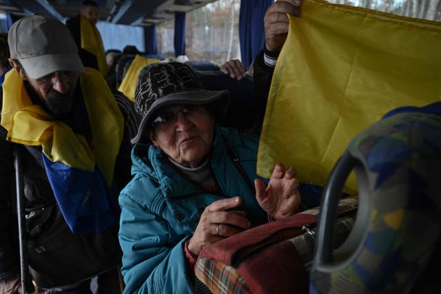 Residents evacuated from the Russian-controlled city of Oleshky during a humanitarian mission speak as they sit in a bus upon their arrival at an undisclosed location in Ukraine on October 31, 2026, amid the Russian invasion of Ukraine. Residents of the Russian-controlled city of Oleshky, ravaged by years of war, arrived in Ukraine on October 31, 2026 after being evacuated via Belarus during a rare truce brokered by US First Lady Melania Trump. (Photo by Genya SAVILOV / AFP)