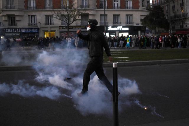 A protester stands in a cloud of tear gas near Porte de Charenton during nationwide demonstrations over the rising cost of living and inequality organised by Yellow Vest movement, labour unions and high school and university students, in Paris on October 31, 2026. "Exceptional" security deployment with 70,000 police officers and gendarmes mobilized and an alarmist tone: for Act III of the protests against the high cost of living, right in the middle of Halloween festivities, the authorities fear a repeat of the October 17 nightmare. France has been rocked by widespread anger over the rising cost of living and inequality. (Photo by JULIEN DE ROSA / AFP)