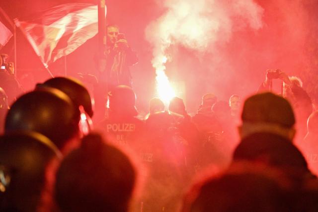 Protesters light flares after a demonstration organised by "GenZ regelt!" (Gen Z has got this!) in Berlin on October 31, 2026. The German demonstrations have been inspired by similar movements across Europe, including in France and Italy, which have seen young protesters voice anger at political elites whom they accuse of ignoring their concerns. (Photo by RALF HIRSCHBERGER / AFP)