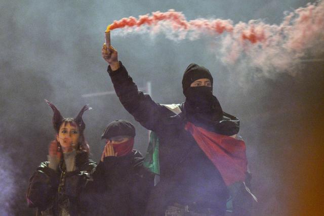 Protesters light smoke flares after a demonstration organised by "GenZ regelt!" (Gen Z has got this!) in Berlin on October 31, 2026. The German demonstrations have been inspired by similar movements across Europe, including in France and Italy, which have seen young protesters voice anger at political elites whom they accuse of ignoring their concerns. (Photo by RALF HIRSCHBERGER / AFP)