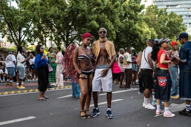 Attendees pose among the crowd during Johannesburg Pride in Sandton, on October 31, 2026. People filled the streets of Sandton City in Johannesburg for Africa’s oldest Pride event, marking 37 years of protest, courage and celebration. Launched in 1990, before South Africa became a democracy, Johannesburg Pride has grown from an act of defiance under apartheid into a continental movement for equality. (Photo by ILARIA FINIZIO / AFP)