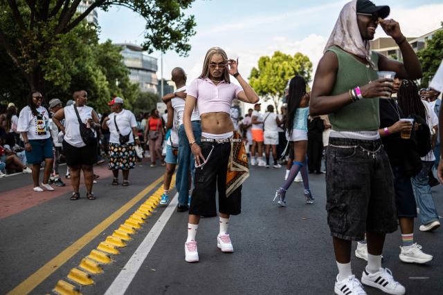 An attendee poses among the crowd during Johannesburg Pride in Sandton, on October 31, 2026. People filled the streets of Sandton City in Johannesburg for Africa’s oldest Pride event, marking 37 years of protest, courage and celebration. Launched in 1990, before South Africa became a democracy, Johannesburg Pride has grown from an act of defiance under apartheid into a continental movement for equality. (Photo by ILARIA FINIZIO / AFP)