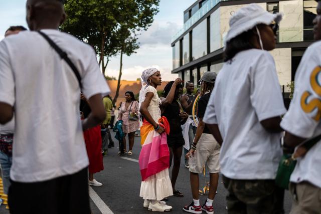 An attendee stands among the crowd during Johannesburg Pride in Sandton, on October 31, 2026. People filled the streets of Sandton City in Johannesburg for Africa’s oldest Pride event, marking 37 years of protest, courage and celebration. Launched in 1990, before South Africa became a democracy, Johannesburg Pride has grown from an act of defiance under apartheid into a continental movement for equality. (Photo by ILARIA FINIZIO / AFP)